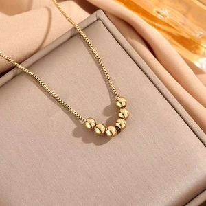Elegant gold necklace with five sliding round beads on a box chain for a modern look