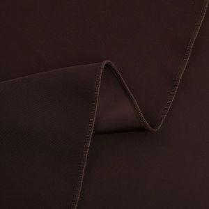 Close-up of dark brown satin dress fabric showing fine texture and overlock stitching