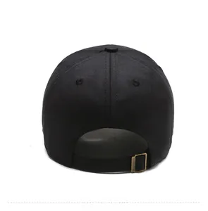 Close-up of black cotton baseball cap back with adjustable bronze metal buckle and stitching