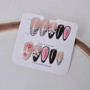 Detail of semi-handmade press-on nails with zebra print, 3D flowers, and gradient patterns