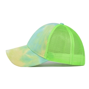 Detail of colorful tie-dye visor with breathable neon green mesh and multi-row stitching
