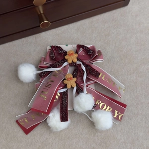 Detail of Christmas bow hair clips with gingerbread man and red glitter ribbons