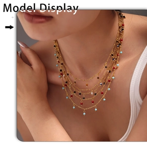 Close-up of bohemian layered gold necklace with colorful beads on a model's collarbone