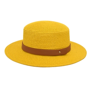 Detail of yellow flat top straw hat with brown faux leather band and metallic buckle