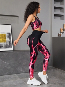 Detail of high-stretch seamless yoga set with vibrant red and pink flame patterns