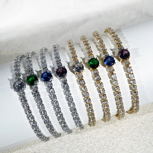 Close-up of luxury gold and silver bracelets set with colorful cubic zirconia stones