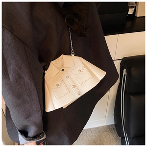 Detail of creative cream white jacket-shaped crossbody bag with metal chain strap