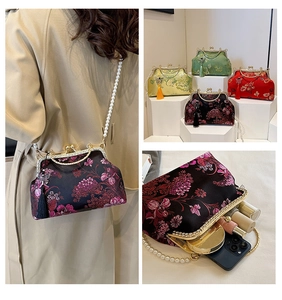 Detail of embroidered Chinese clutch with pearl chain, tassel, and daily essentials storage