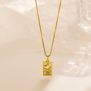 Detailed macro view of gold tarot-style pendant with celestial mother of pearl inlay