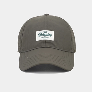 Close-up of olive green quick-dry baseball cap with laser-cut holes and Paradise patch
