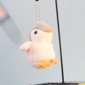 Close-up of cute grey penguin plush keychain with orange beak and metal bead chain