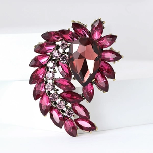 Vintage gold alloy brooch with magenta rhinestones and teardrop crystal on white block