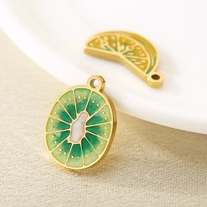 Macro view of gold-plated stainless steel kiwi fruit pendants with green enamel details