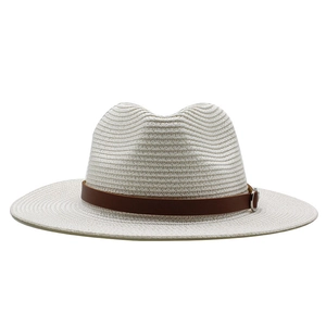 Detailed weave texture of a white Panama straw hat with a brown faux leather band