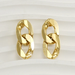 Macro detail of 18K gold plated Cuban link earrings with a high-polished mirror finish