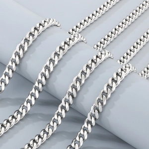 Macro view of polished silver cuban link chain with intricate metal texture and details