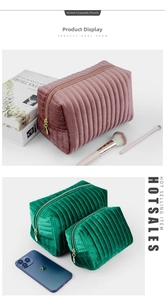 Macro detail of quilted velvet cosmetic bags in pink and forest green with gold zippers