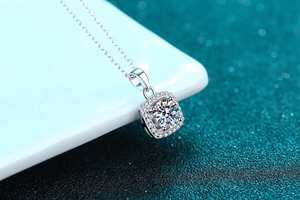 Macro detail of square halo Moissanite pendant on a delicate S925 silver chain