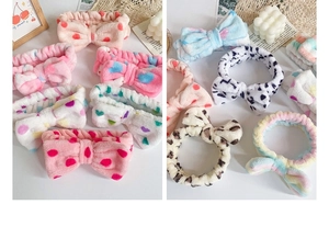 Close-up of fluffy coral fleece headbands with leopard print and polka dot bow details