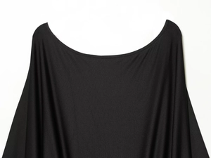 Detailed view of black knitted short dress collar featuring fine synthetic fiber texture