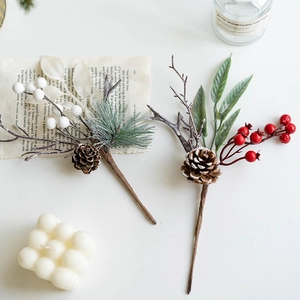 Christmas decoration sprays with red berries, pine cones and foliage in a cozy home setting