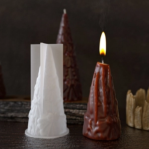 Detailed view of cone-shaped silicone mold and textured brown scented candle with flame