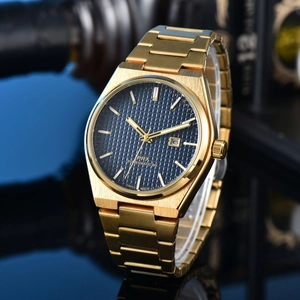 Macro detail of gold watch with blue waffle dial, calendar window and integrated band