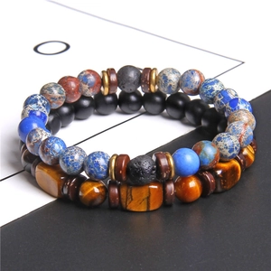 Close-up of natural blue stone and tiger eye bead bracelets with black lava stones