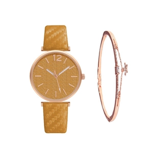 Close-up of yellow leaf pattern dial and rose gold quartz watch with matching bracelet
