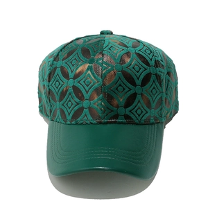 Detail of retro geometric pattern and leather brim on dark green baseball cap