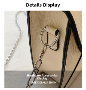 Detailed macro view of silver polished D-ring and chain strap on Saffiano leather bag