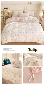 Close-up of pink tulip floral pattern and delicate lace trim on washed cotton bedding