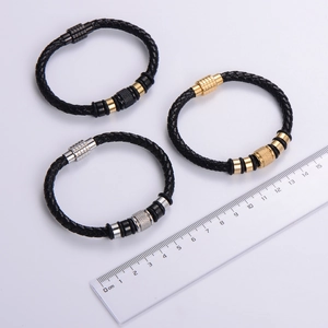 Braided black leather bracelet for men with silver and gold metal charms and magnetic clasp