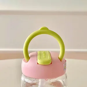 Portable pink glass water bottle with a convenient carrying ring and leakproof straw lid