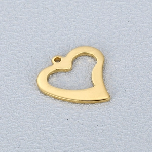 Polished gold heart-shaped stainless steel pendant with hollow design on textured surface