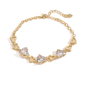 Gold-plated heart bracelet featuring three sparkling cubic zirconia and adjustable chain