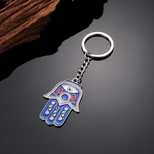 Bohemian Hamsa keychain with blue evil eye pendant and tassels on black mirror base