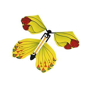 Detailed view of yellow flying butterfly magic toy with colorful wings and black clockwork
