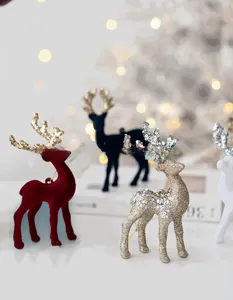 Close-up of assorted flocked and glitter Christmas reindeer ornaments with gold antlers