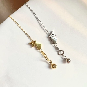 Detail of S925 silver necklaces in gold and silver finish with heart and A pendants