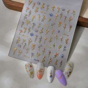 Detailed macro of 3D gold embossed floral nail art stickers on various manicured nails