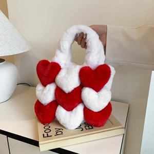 Chic red and white heart pattern plush tote bag for women in a cozy indoor setting