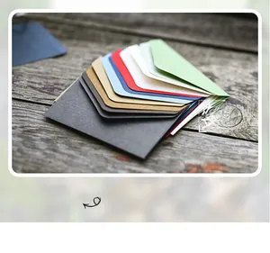 Macro shot of colorful mini triangular vintage envelopes on a rustic wood surface