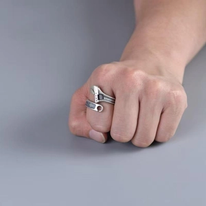 Adjustable wrench shaped ring in antique silver finish with scale numbers on a hand