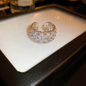 Close-up of wide open ring featuring multi-row pave-set white zircons in silver finish