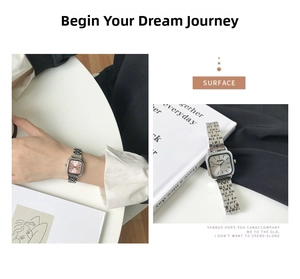 Detail of silver square watch with link strap and minimalist pink dial on wrist