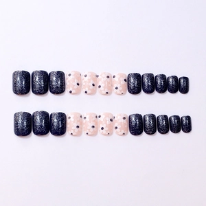 24-piece press-on nails with blue glitter and fresh daisy floral designs on white background