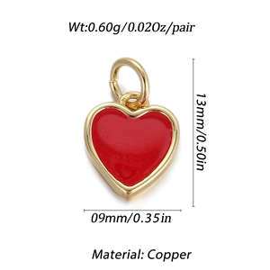 Detail view of a 13mm red heart-shaped copper pendant with 18K gold-plated frame