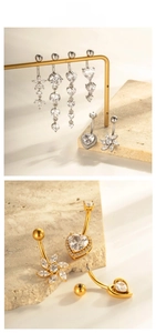 Detail of heart-shaped and floral zircon belly rings with elegant long tassels