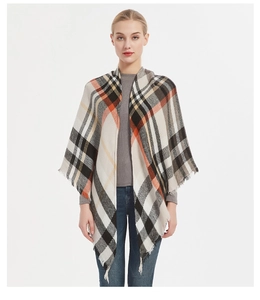 Detail of classic black, white, and orange plaid cashmere-like shawl with fringe tassels